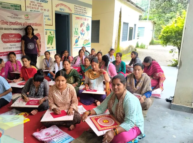 Women learning Aipan art under the Guru Shishya handicraft training programme